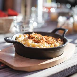 Enjoy Alpine cuisine - cheese dumplings on the Gafadura in Liechtenstein Cheese dumplings with fried onions at the Gafadura hut in Liechtenstein - regional specialty in an alpine setting